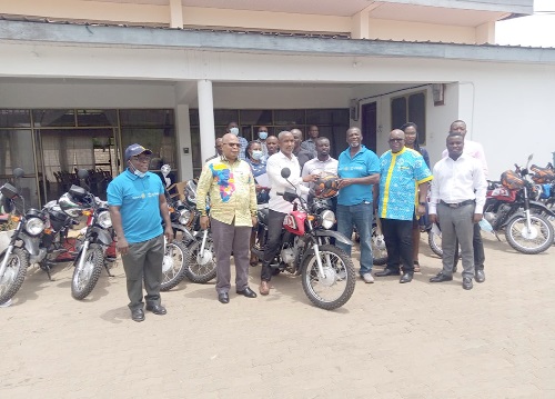 Mr Ako Odotei (3rd right), Chairman of Host Committee of Rotary International-USAID Water and Sanitation Project, handing over one of the motorbikes to Mr Seth Sabutey (seated on a motorbike), Presiding Member of the Shai Osudoku District Assembly, while others look on. Picture: BENJAMIN XORNAM GLOVER
